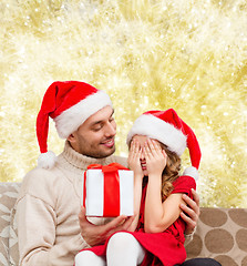 Image showing smiling daughter waiting for present from father