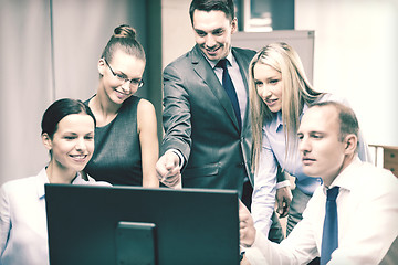 Image showing business team with monitor having discussion