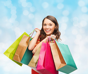 Image showing smiling woman with colorful shopping bags