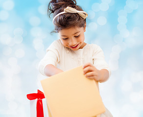 Image showing smiling little girl with gift box