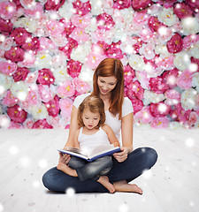 Image showing happy mother with little girl and book