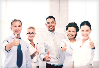 Image showing business team showing thumbs up in office