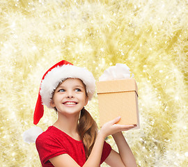 Image showing smiling girl in santa helper hat with gift box