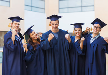 Image showing group of smiling students in mortarboards