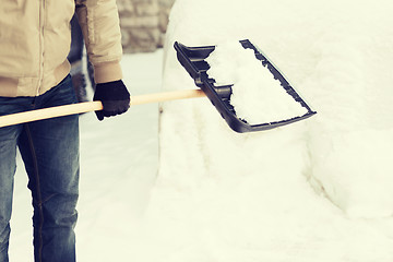 Image showing closeup of man shoveling snow from driveway