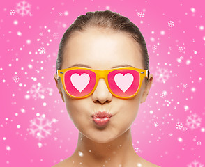 Image showing smiling teenage girl in pink sunglasses