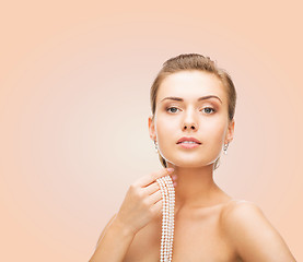 Image showing beautiful woman with pearl earrings and bracelet