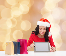 Image showing smiling woman with shopping bags and tablet pc