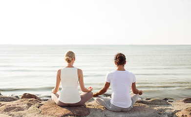 Image showing couple making yoga exercises outdoors