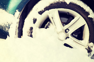 Image showing closeup of car wheel stuck in snow