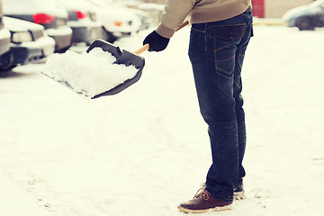 Image showing closeup of man shoveling snow from driveway