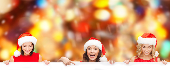 Image showing women in santa helper hat with blank white board