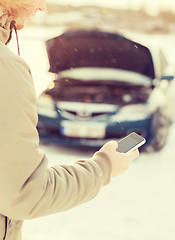 Image showing closeup of man with broken car and cell phone