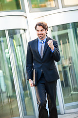 Image showing Motivated businessman punching the air