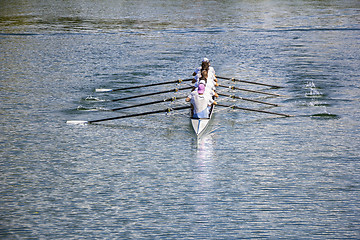 Image showing Eight men rowing