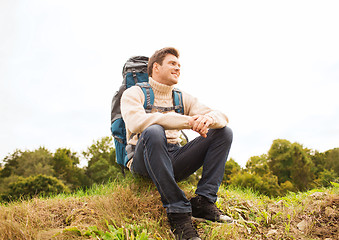 Image showing smiling man with backpack hiking