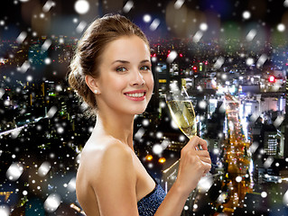 Image showing smiling woman holding glass of sparkling wine