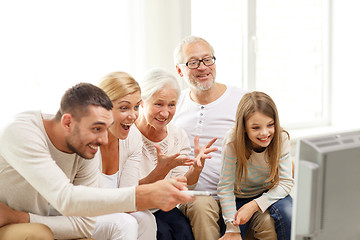 Image showing happy family watching tv at home