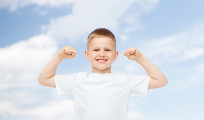 Image showing happy little boy in white t-shirt flexing biceps