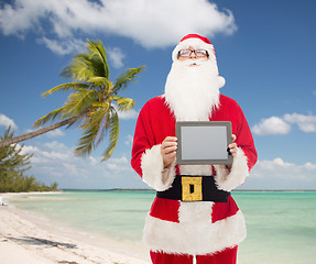 Image showing man in costume of santa claus with tablet pc