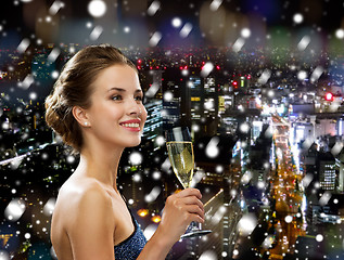 Image showing smiling woman holding glass of sparkling wine