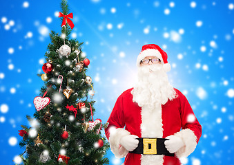 Image showing man in costume of santa claus with christmas tree