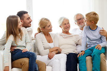 Image showing happy family sitting on couch at home