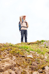 Image showing smiling man with backpack hiking