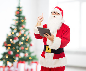 Image showing man in costume of santa claus with tablet pc