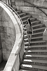 Image showing woman in sunglasses and dress walking down stairs