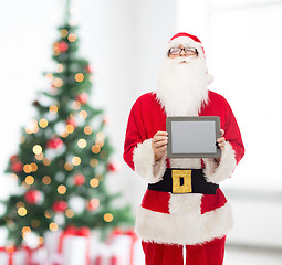 Image showing man in costume of santa claus with tablet pc