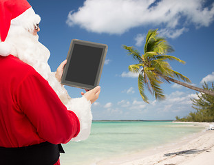 Image showing man in costume of santa claus with tablet pc