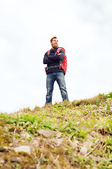 Image showing smiling man with backpack hiking