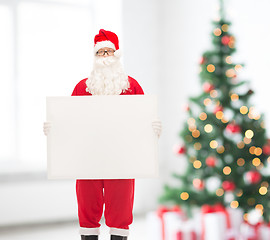 Image showing man in costume of santa claus with billboard