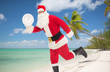 Image showing man in costume of santa claus with clock