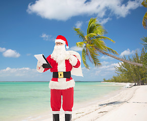 Image showing man in costume of santa claus with notepad and bag