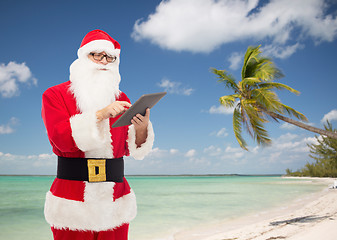 Image showing man in costume of santa claus with tablet pc