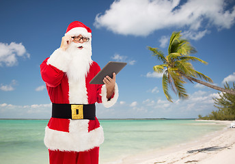 Image showing man in costume of santa claus with tablet pc