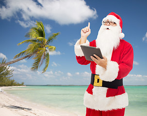 Image showing man in costume of santa claus with tablet pc