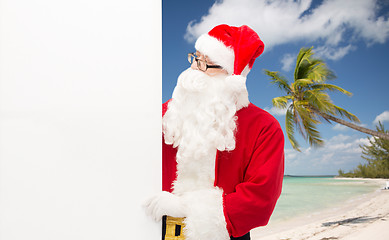 Image showing man in costume of santa claus with billboard