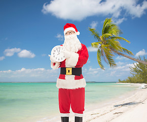 Image showing man in costume of santa claus with clock