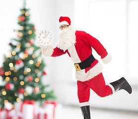 Image showing man in costume of santa claus with clock