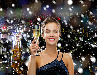 Image showing smiling woman holding glass of sparkling wine