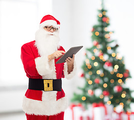 Image showing man in costume of santa claus with tablet pc