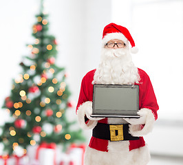 Image showing man in costume of santa claus with laptop