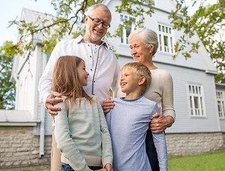 Image showing happy family in front of house outdoors