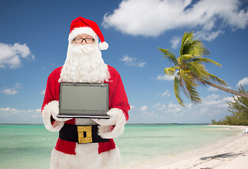 Image showing man in costume of santa claus with laptop