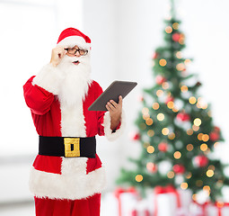 Image showing man in costume of santa claus with tablet pc