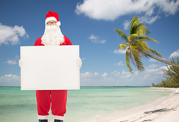 Image showing man in costume of santa claus with billboard