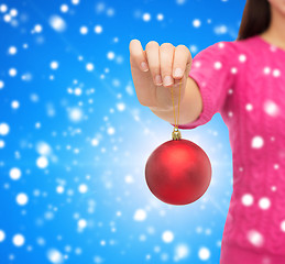 Image showing close up of woman in sweater with christmas ball